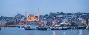 Traditionally Turkish Prints: New Mosque (Yeni Cami) on the banks of the Golden Horn at night with Hagia Sophia