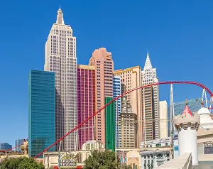 Entertainment Prints: New York New York Hotel and Casino features roller coaster in Las Vegas Nevada USA under clear blue sky