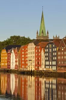 Images Dated 25th June 2009: Nidaros Cathedral and old fishing warehouses reflected in the River Nidelva, Trondheim
