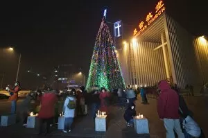 Night time illuminations of a Christmas tree and decorations at a Christian church celebrating in Beijing