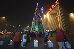 Celebrating Prints: Night time illuminations of a Christmas tree and decorations at a Christian church celebrating in Beijing
