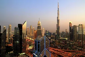 Economy Prints: Night view of Central Dubai with Burj Khalifa shining brightly above the skyline during evening hours