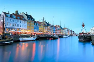 Nyhavn Prints: Night view of the illuminated harbour and canal of the entertainment district of Nyhavn