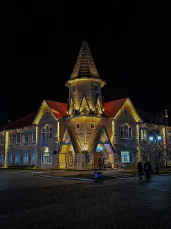 Center Prints: Night view of Naryan-Mar square showing illuminated building and people walking in Nenets Autonomous Okrug