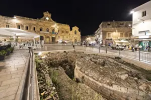 Contrasts Prints: Night view of the Town Hall and ancient ruins in the medieval old town of Ostuni