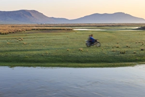 Motorcycle Prints: Nomads on motorcycle pass in a blur, river and distant gers, dawn, Nomad camp, Gurvanbulag