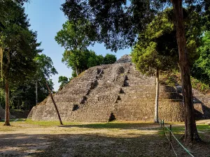 Central Prints: North Acropolis at Yaxha shows ancient stone structures and surrounding trees in the sunlight near Peten