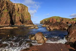 North Ham Bay, deep inlet, lichen covered red granite cliffs and stacks, seaweed