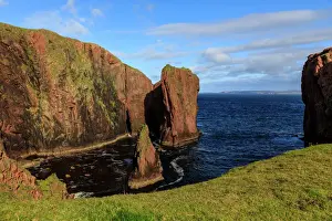 North Ham, lichen covered huge red granite cliffs and stacks, Muckle Roe Island, Shetland
