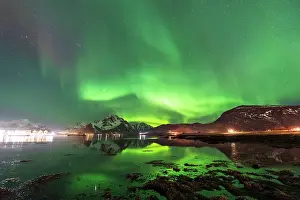 Night Sky Prints: Northern lights (Aaurora borealis) on snowy mountains reflecting in the calm water of the fjord in the Arctic landscape