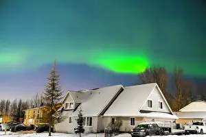 Hemisphere Prints: Northern lights (Aurora borealis) illuminate the night sky along the horizon behind mountains near Anchorage