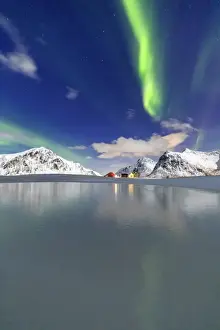 Northern Lights (aurora borealis) reflected in the cold waters, Flakstad, Lofoten Islands