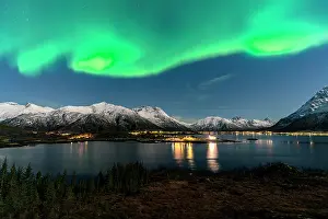 Northern Prints: Northern Lights display above Sildpollnes village in Lofoten Islands during night hours