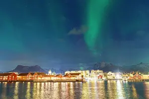 Svolvaer Prints: Northern Lights illuminate Svolvaer while boats rest in the harbor during a winter night in Norway