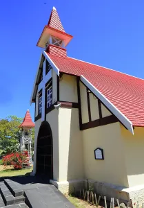 Bright Prints: Notre-Dame Auxiliatrice de Cap Malheureux stands against a clear sky in Mauritius with its unique architecture