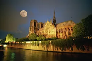 Notre Dame Cathedral at night, with moon rising above, Paris, France, Europe