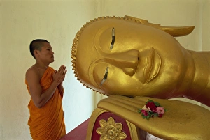 One Young Man Only Prints: Novice monk and reclining Buddha, Wat Pha Baat Tai, Luang Prabang, Laos