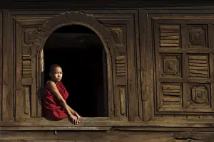 Tee Nager Prints: Novice monk sitting in window of 18th century wooden monastery of Nat Taung Kyaung