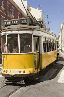 A number 28 tram runs along the scenic route popular with tourists in the Alfama district of Lisbon