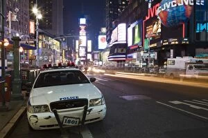 NYPD police car parked at Times Square at night, Manhattan, New York, United States of America