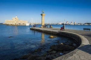 Greek Culture Gallery: The old Agios Nikolaos fortress and lighthouse in Mandraki Harbour with deer statue in foreground