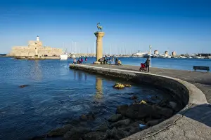 Curved Prints: The old Agios Nikolaos fortress and lighthouse in Mandraki Harbour with deer statue in foreground