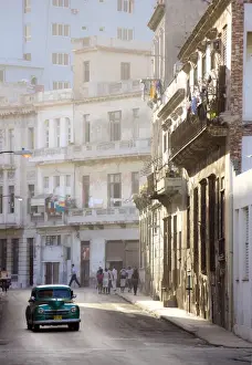 Cars Prints: Old American car driving along quiet street in Havana Centro, Havana, Cuba