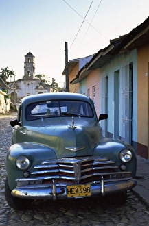 Old American car parked on cobbled street, Trinidad, Cuba, West Indies, Central America