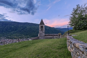 Old bell tower of the Xenodochio of Santa Perpetua at sunrise, Tirano, province of Sondrio