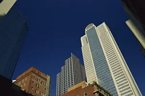 Old brick building contrasts with modern skyscrapers in Dallas