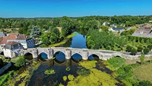 Birds Prints: Old bridge near Abbey Church of Saint-Savin-sur-Gartempe showing river and green landscape in France