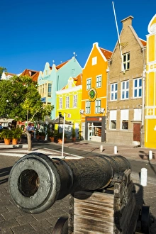 Bright Color Prints: Old cannon in front of Dutch houses at the Sint Annabaai in Willemstad