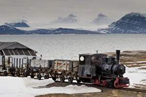 Old coal train with snow, fjord and mountains, Ny Alesund, Spitsbergen (Svalbard), Arctic, Norway, Scandinavia, Europe