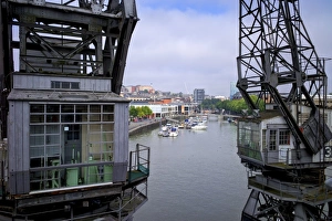 Crane Prints: Old dockside cranes frame the harbour, Bristol, England, United Kingdom, Europe