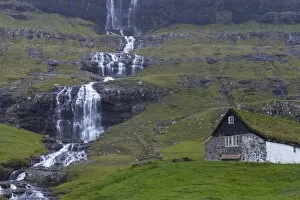 Old farm at Saksun and waterfall, Streymoy, Faroe Islands (Faroes), Denmark, Europe