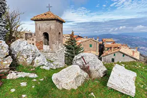 Bells Prints: Old Italian mountain village with bell tower in the foreground