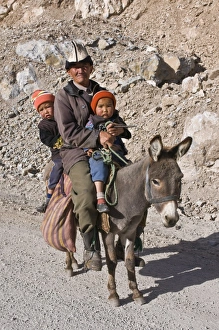 Donkey Prints: Old Kyrgyz man riding with twins on a donkey, Gulcha, Kyrgyzstan, Central Asia, Asia