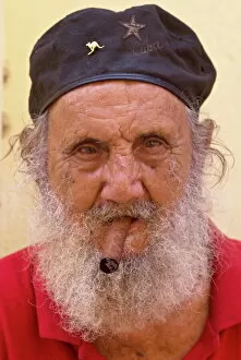 An old man with cap and white beard smoking a cigar, Havana, Cuba, West Indies