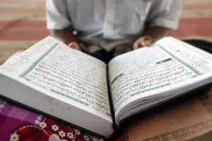 Quran Prints: Old man reading Quran sitting on carpet in a mosque, Phnom Penh, Cambodia, Indochina