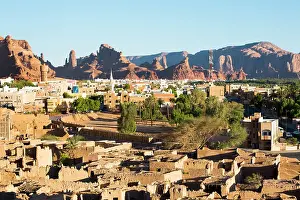 Neighborhoods Prints: Old mudbrick village under reconstruction with new neighborhoods in the background