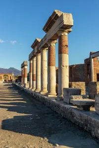 Columns Prints: Old Pompei ruins show ancient columns and structures under clear sky in Campania, Italy