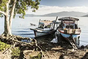 Lake Toba Prints: Old rusty fishing boats in a village at Lake Toba (Danau Toba), North Sumatra, Indonesia