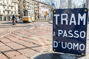 An old sign in Italian that says Trams go to Duomo, with a traditional Milanese tram An old sign in Italian that says Trams go to Duomo, with a traditional Milanese tram