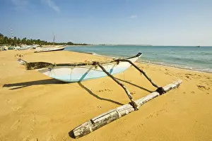 Eastern Province Prints: Old style outrigger fishing boat and post-2004 tsunami foreign donated newer ones beyond