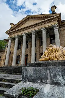 Columns Prints: Old theatre building with lion statue in Gagra