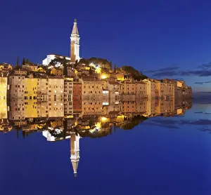 Rovinj Prints: Old town with cathedral of St. Euphemia reflecting in the water at night