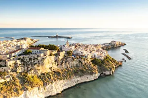 Apulia Prints: Old town of Vieste perched on cliffs at sunrise, aerial view, Foggia province