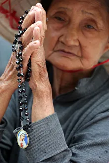 Indigenous Culture Prints: Old Vietnamese woman praying with prayer beads, St. Philip Church (Huyen Sy Church)