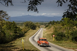 Trinidad Prints: Old vintage American car on a road outside Trinidad, Sancti Spiritus Province, Cuba