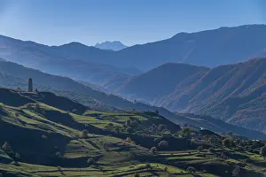 Season Prints: Old watchtower stands against mountains in Itum-Kali